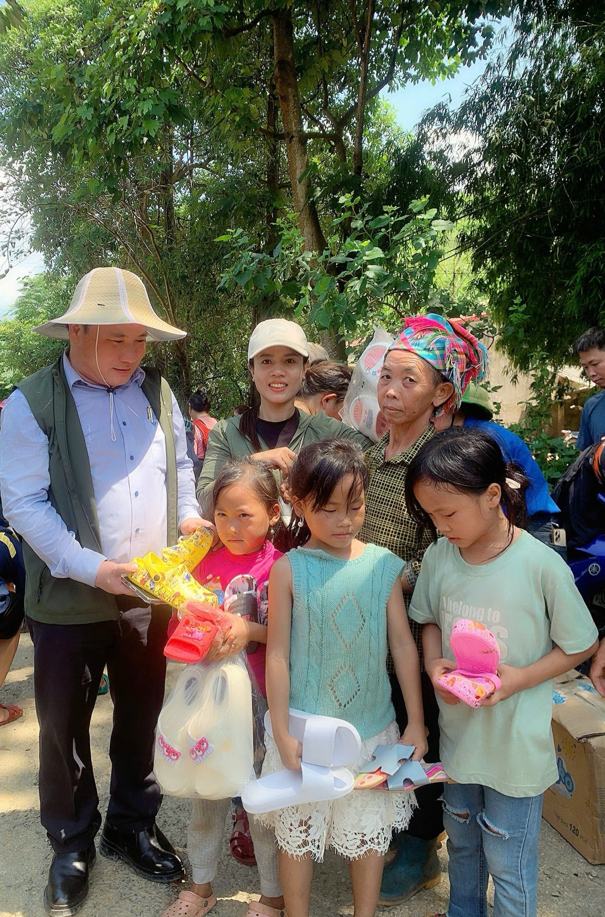 Ông Phạm Đình Vương, Trưởng VPĐD Trung ương VACHE tại TP. HCM kiêm Giám đốc Trung Tâm UNESCO Văn Hoá Thông Tin Truyền Thông và bà Cao Thị Tình trưởng nhóm Thiện Nguyện Xanh Lêna Tình trao quà cho bà con tại bản A Mú Sung, huyện Bát Xát