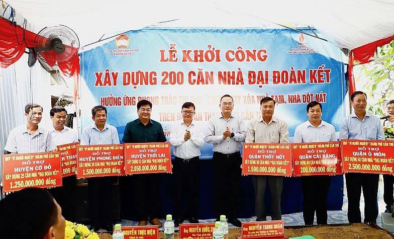 Ông Nguyễn Trung Nhân, Chủ tịch Ủy ban MTTQVN thành phố Cần Thơ và ông Nguyễn Quốc Thịnh, Phó Tổng Giám đốc Tổng Công ty Cổ phần Vận tải Dầu khí trao bảng tượng trưng hỗ trợ xây dựng nhà đại đoàn kết cho đại diện Mặt trận các quận, huyện.