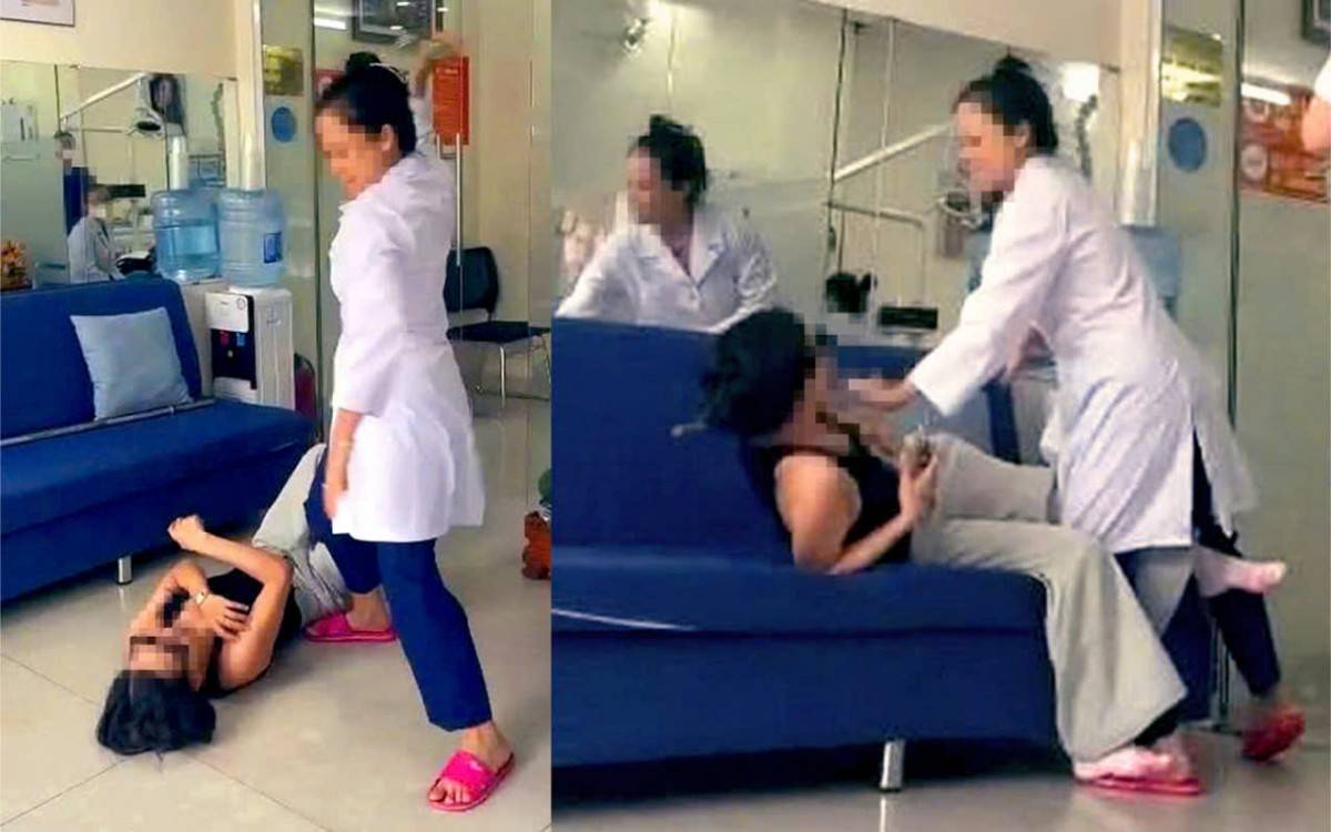 Người phụ nữ mặc áo blouse trắng kéo khách hàng nằm xuống sàn nhà, giật điện thoại của khách hàng rồi đập bể nát màn hình - Ảnh cắt từ clip do chị T. cung cấp