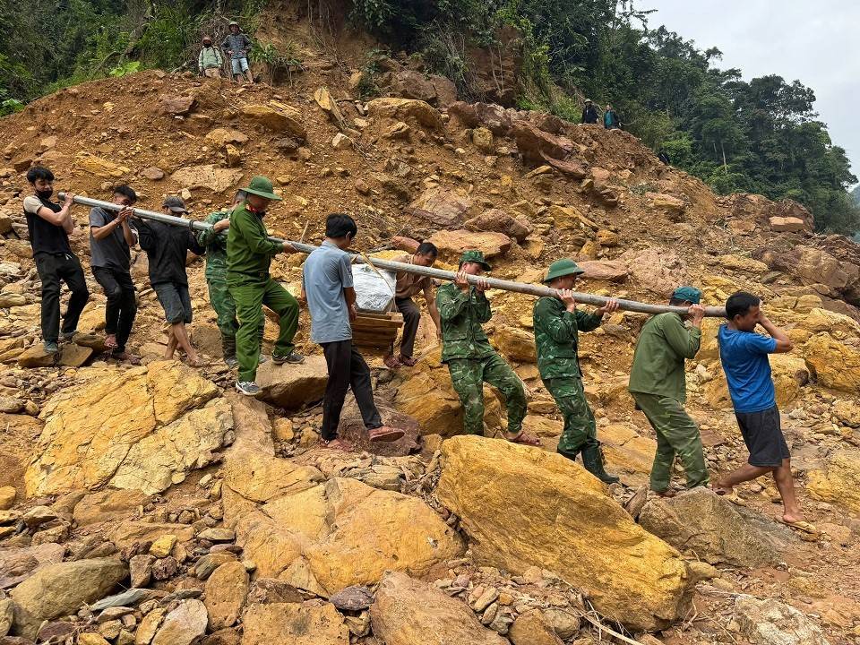 Lực lượng Quân đội, Công an và bà con dân bản hỗ trợ vận chuyển vật tư, thiết bị và bản