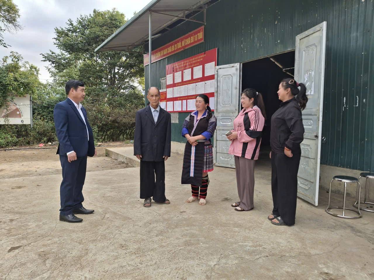 Phó Bí thư Đảng ủy, Chủ tịch UBND, Trưởng Ban bầu cử xã Khao Mang Sùng A Bình trao đổi với cử tri Trống Gầu Bua