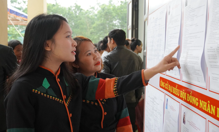Cử tri đồng bào Rục xem danh sách các ứng cử viên niêm yết tại các điểm bầu cử.png