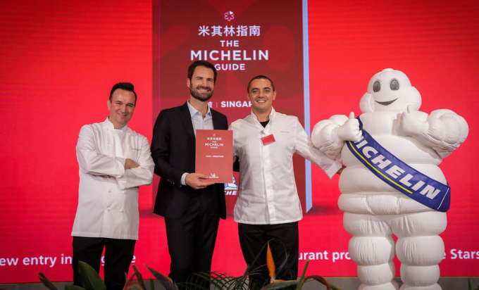 Đại diện Michelin chụp ảnh c&amp;ugrave;ng c&amp;aacute;c đầu bếp v&amp;agrave; linh vật của Michelin trong một buổi trao sao tại Singapore. Ảnh: Guide. Michelin