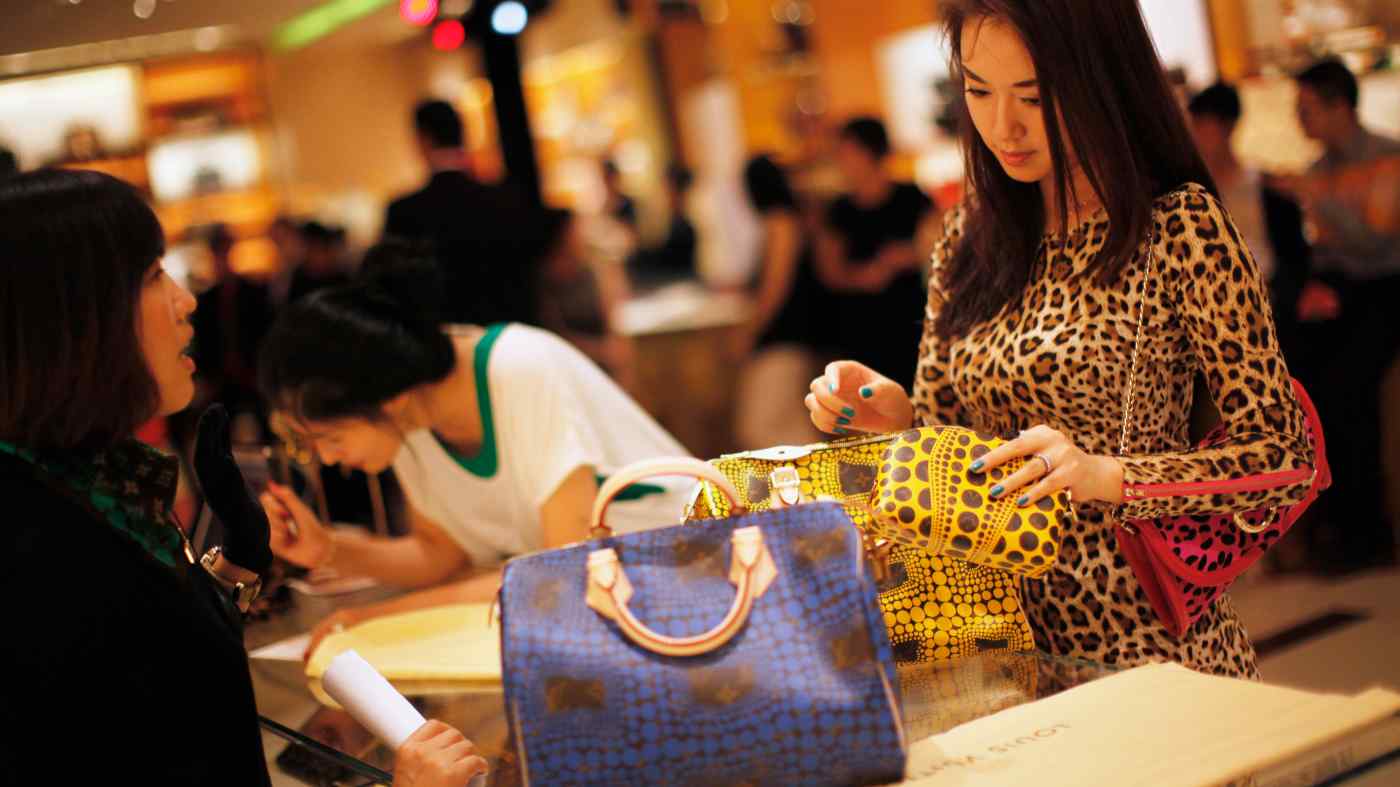 Một phụ nữ mua sắm tại một cửa h&amp;agrave;ng Louis Vuitton ở Thượng Hải. Những người gi&amp;agrave;u c&amp;oacute; ở Trung Quốc l&amp;agrave; những người mua lớn c&amp;aacute;c thương hiệu cao cấp to&amp;agrave;n cầu trong những năm gần đ&amp;acirc;y. &amp;copy; Reuters