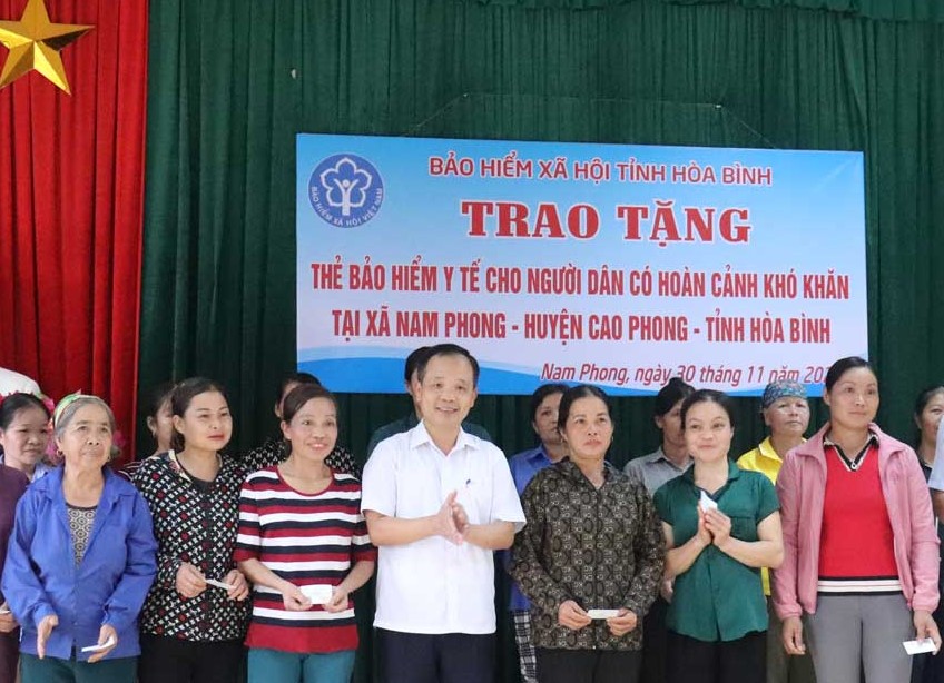 Đại diện l&amp;atilde;nh đạo BHXH tỉnh H&amp;ograve;a B&amp;igrave;nh  trao tặng thẻ BHYT cho c&amp;aacute;c hộ c&amp;oacute; ho&amp;agrave;n cảnh kh&amp;oacute; khăn ở x&amp;atilde; Nam Phong (Cao Phong).